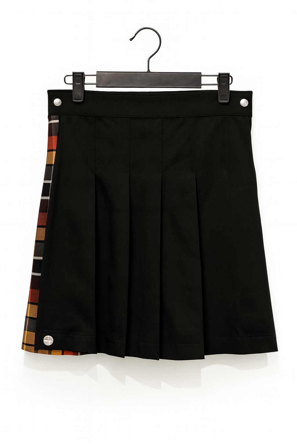 Black pleated kilt with plaid accents on a hanger against a white background
