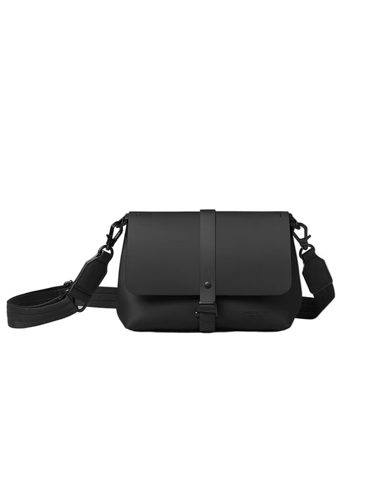 Black vegan bag with a strap on a light white background