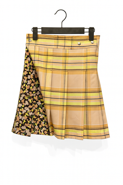 Plaid kilt with floral overlay on a hanger against a white background