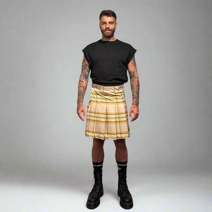 Man wearing a beige plaid kilt on a gray background
