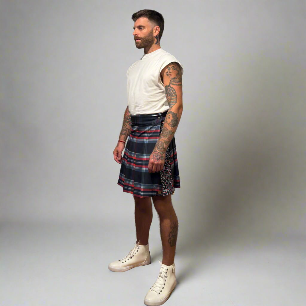 Man wearing a plaid kilt on a gray background