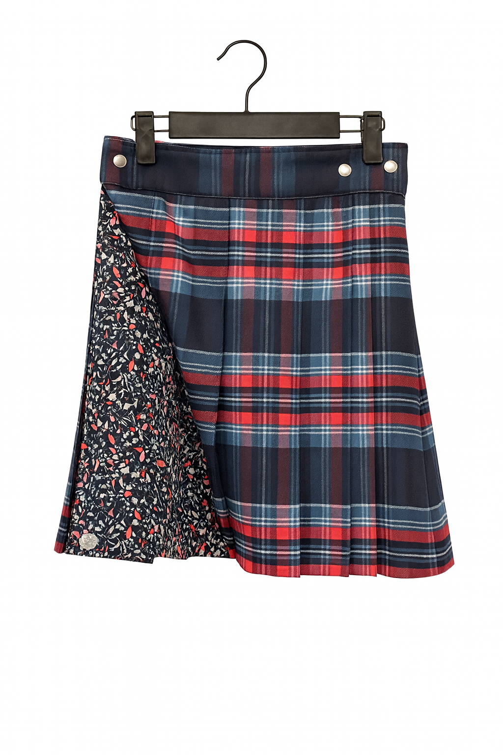 Plaid kilt with floral pattern on a hanger against a white background