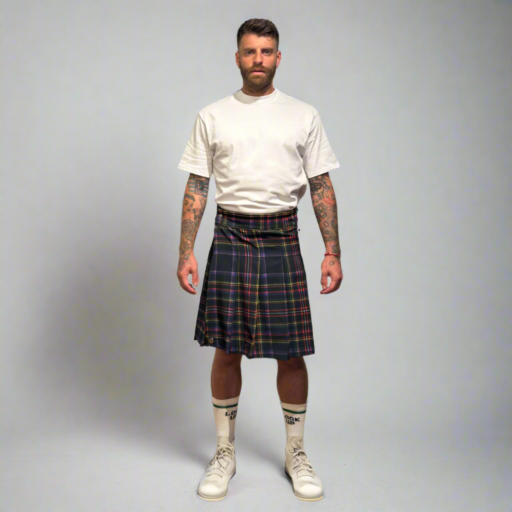 Man wearing a plaid kilt on a plain background