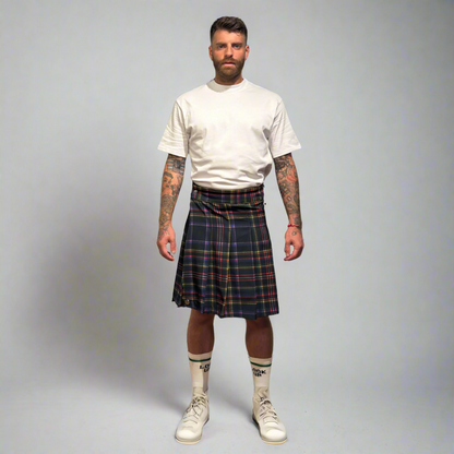 Man wearing a plaid kilt on a plain background