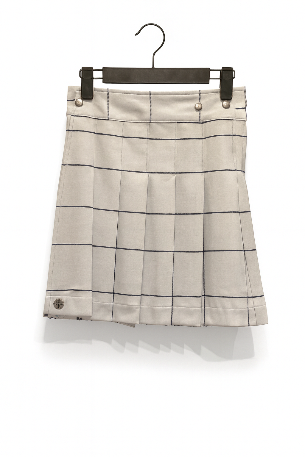 White Plaid kilt on a hanger against a white background