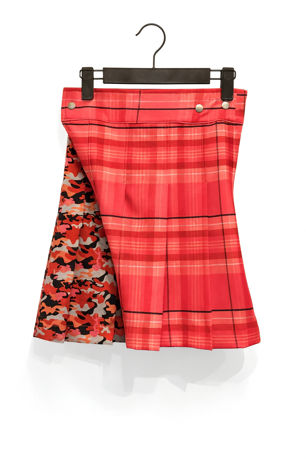 Pink plaid kilt with camouflage pattern underneath on a hanger against a white background
