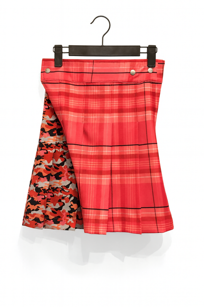 Pink plaid kilt with camouflage pattern underneath on a hanger against a white background