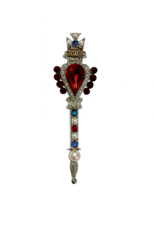 Decorative scepter pin with gemstones on a white background